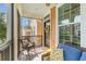 Cozy screened porch with seating and view of the neighborhood at 1065 Clifton Springs Ln, Winter Springs, FL 32708