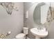 Charming powder room features modern fixtures, stylish decor, and a round mirror at 1065 Clifton Springs Ln, Winter Springs, FL 32708