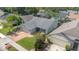 Aerial view of a well-maintained home with a brick driveway, lush lawn, and mature landscaping at 1096 Dees Dr, Oviedo, FL 32765