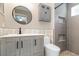 Modern bathroom featuring new gray vanity, updated fixtures, round mirror, and walk-in shower at 1096 Dees Dr, Oviedo, FL 32765