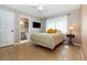 Comfortable bedroom with en suite bathroom, decorated with neutral colors and bright yellow throw pillows at 1096 Dees Dr, Oviedo, FL 32765