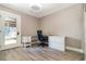 Well-lit home office featuring built-in desk, file cabinet and light wood laminate flooring at 1096 Dees Dr, Oviedo, FL 32765