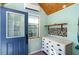 Bright shed interior featuring wood ceiling, a white dresser and blue door adding a touch of color at 1096 Dees Dr, Oviedo, FL 32765