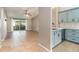 Open-concept living room with a view of the updated kitchen and screened patio at 1096 Dees Dr, Oviedo, FL 32765