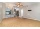 Open-concept living room with tile floors and view of a beautifully tiled kitchen bar at 1096 Dees Dr, Oviedo, FL 32765