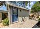 Charming shed with a blue door and wood deck, perfect for storage or a private retreat at 1096 Dees Dr, Oviedo, FL 32765