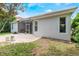 Image shows the home's backyard with a screened lanai, manicured lawn, and lush landscaping at 11878 Via Lucerna Cir, Windermere, FL 34786