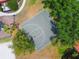 Aerial view of community basketball court with lush trees and playground nearby at 11878 Via Lucerna Cir, Windermere, FL 34786