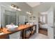 Bright bathroom features a double sink vanity, modern fixtures, and a view to the main bedroom at 11878 Via Lucerna Cir, Windermere, FL 34786