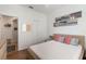 Neutral bedroom with a platform bed featuring decorative pillows, with beach photos hung on the wall at 11878 Via Lucerna Cir, Windermere, FL 34786