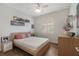 Bright bedroom with wood floors, a ceiling fan and sunny window at 11878 Via Lucerna Cir, Windermere, FL 34786