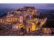 Scenic cityscape view of a historic town on a hill, illuminated at night with lights at 11878 Via Lucerna Cir, Windermere, FL 34786