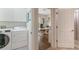 Hallway view into the office featuring a laundry room, and a full bathroom at 11878 Via Lucerna Cir, Windermere, FL 34786