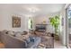 Inviting living room featuring a gray sofa, neutral walls, and stylish decor at 11878 Via Lucerna Cir, Windermere, FL 34786