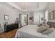 Bright main bedroom featuring hardwood floors, modern light fixture, and outdoor access at 11878 Via Lucerna Cir, Windermere, FL 34786