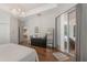 Spacious main bedroom features hardwood floors, tray ceiling, and sliding glass door to the backyard at 11878 Via Lucerna Cir, Windermere, FL 34786