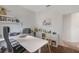 Bright home office with a white desk, floating shelves, and a large monitor at 11878 Via Lucerna Cir, Windermere, FL 34786
