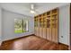 Bedroom featuring a built-in display cabinet and abundant natural light from the large window at 1218 Fairway Dr, Winter Park, FL 32792