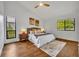Serene bedroom with a plush bed, soft lighting, and large windows overlooking lush greenery at 1218 Fairway Dr, Winter Park, FL 32792