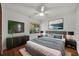 Modern bedroom features a gray bed, wooden floors, and a ceiling fan for a relaxing retreat at 1218 Fairway Dr, Winter Park, FL 32792