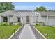 Inviting front entrance with well-maintained landscaping and a decorative pergola at 1218 Fairway Dr, Winter Park, FL 32792