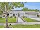 Charming single-story home with a well-manicured lawn and inviting walkway at 1218 Fairway Dr, Winter Park, FL 32792