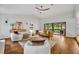 Spacious living room with a leather sofa, contemporary decor, and sliding glass doors to the backyard at 1218 Fairway Dr, Winter Park, FL 32792