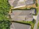 An aerial view of a home with a well-maintained roof, surrounded by lush greenery and neighboring properties at 12724 Bideford Ave, Windermere, FL 34786