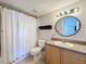 Bathroom featuring a shower with curtain, vanity with sink, and updated light fixture at 12724 Bideford Ave, Windermere, FL 34786
