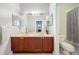 Bathroom with double sinks, vanity, and a separate toilet area at 12724 Bideford Ave, Windermere, FL 34786