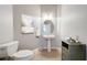 Powder bathroom with pedestal sink, toilet and decorative details at 12724 Bideford Ave, Windermere, FL 34786