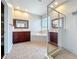 Bright bathroom boasts double vanity, soaking tub, glass shower, and tiled floors creating a luxurious retreat at 12724 Bideford Ave, Windermere, FL 34786