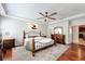 Spacious bedroom featuring hardwood floors, ceiling fan, and a decorative wrought iron bed frame at 12724 Bideford Ave, Windermere, FL 34786