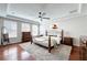 Light-filled bedroom with hardwood floors, ceiling fan, and a cozy area rug creating a welcoming space at 12724 Bideford Ave, Windermere, FL 34786