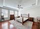 Bedroom with a tray ceiling, ceiling fan and three windows providing natural light at 12724 Bideford Ave, Windermere, FL 34786