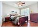 Cozy bedroom with wood floors, decorative painting and a window at 12724 Bideford Ave, Windermere, FL 34786