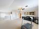Spacious bonus room featuring ample seating, exercise equipment, and a connected bathroom at 12724 Bideford Ave, Windermere, FL 34786
