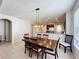 Dining room showcasing an open layout with views of the kitchen and wood floors at 12724 Bideford Ave, Windermere, FL 34786