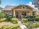 Charming single-Gathering home features a well-manicured lawn, inviting front porch and craftsman-style architectural details at 12724 Bideford Ave, Windermere, FL 34786