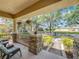 Inviting front porch with stone pillars, comfortable seating, and hanging flower baskets, offering a cozy outdoor space at 12724 Bideford Ave, Windermere, FL 34786