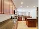 Kitchen showcasing stainless steel appliances, tile floors, wood cabinets, and granite countertops at 12724 Bideford Ave, Windermere, FL 34786