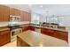 Bright, open kitchen features stainless steel appliances, a kitchen island, and easy access to dining and living areas at 12724 Bideford Ave, Windermere, FL 34786