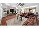 Spacious living room with a large TV and comfortable leather sofa at 12724 Bideford Ave, Windermere, FL 34786