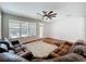 Living room featuring a ceiling fan, hardwood floors, and a large window at 12724 Bideford Ave, Windermere, FL 34786