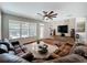 Bright living room with a large leather sofa and entertainment center at 12724 Bideford Ave, Windermere, FL 34786
