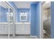 Bathroom featuring modern white vanity with granite countertop and a mirrored closet at 135 Heron Bay Cir, Lake Mary, FL 32746