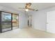 A bright and airy bedroom with a sliding glass door leading to a balcony and neutral carpet at 135 Heron Bay Cir, Lake Mary, FL 32746