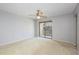 An empty bedroom with sliding glass doors to a balcony, with a ceiling fan at 135 Heron Bay Cir, Lake Mary, FL 32746