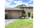 Charming exterior view of home, showcasing a two-car garage and manicured landscaping at 135 Heron Bay Cir, Lake Mary, FL 32746