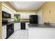 Kitchen features granite countertops, white cabinets, and modern black appliances at 135 Heron Bay Cir, Lake Mary, FL 32746